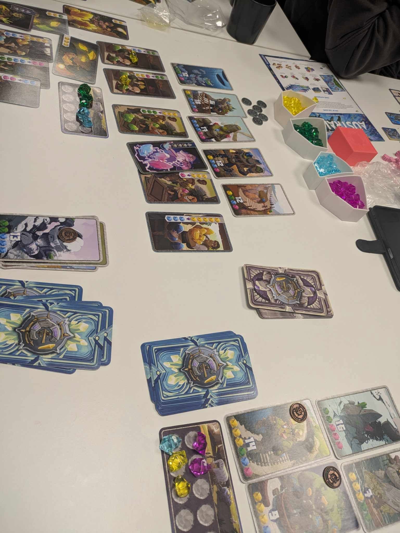 Cards and gems laid out mid-game on the table.